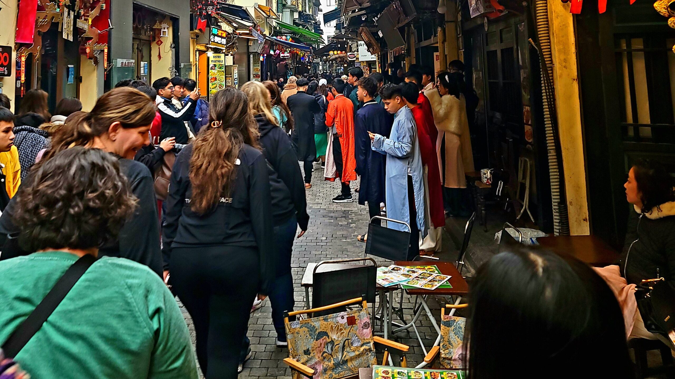 group of people walking through an alley in hanoi vietnam