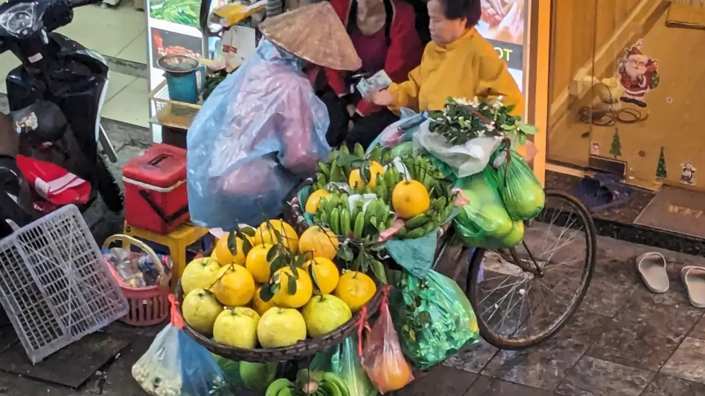 women trying to sell fruit in hanoi vietnam