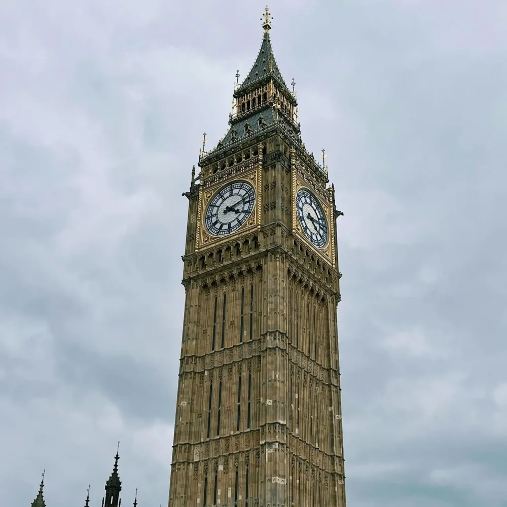 Stunning low-angle view of Big Ben in London with a dramatic cloudy sky.
