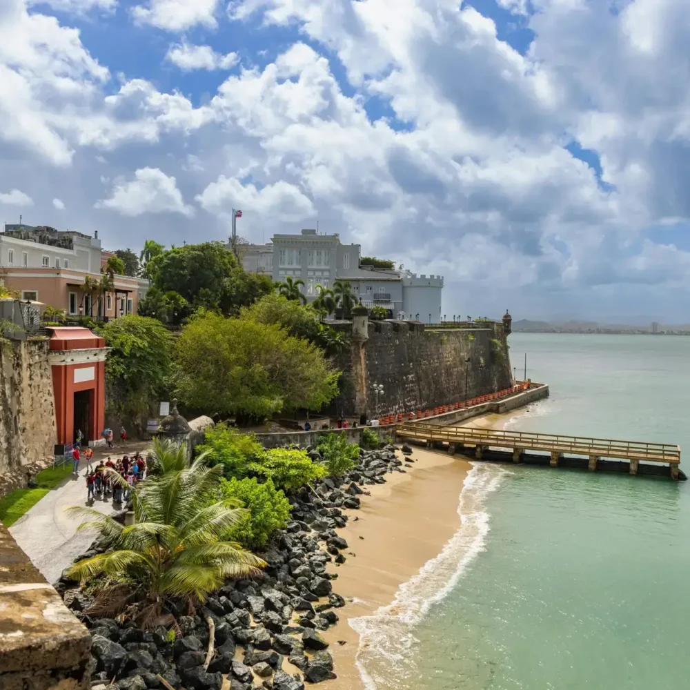 Explore the scenic view of Old San Juan's historic coastal fortifications by the sea in Puerto Rico
