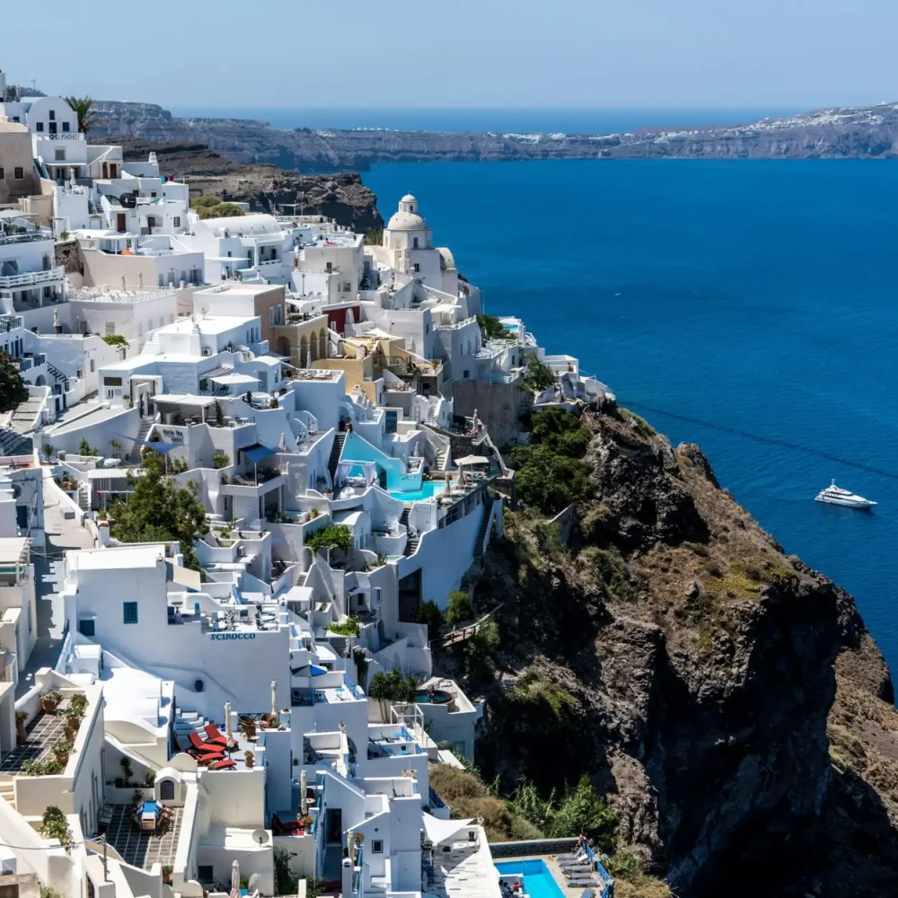 Explore breathtaking Santorini with white-washed buildings overlooking the Aegean Sea. Greece