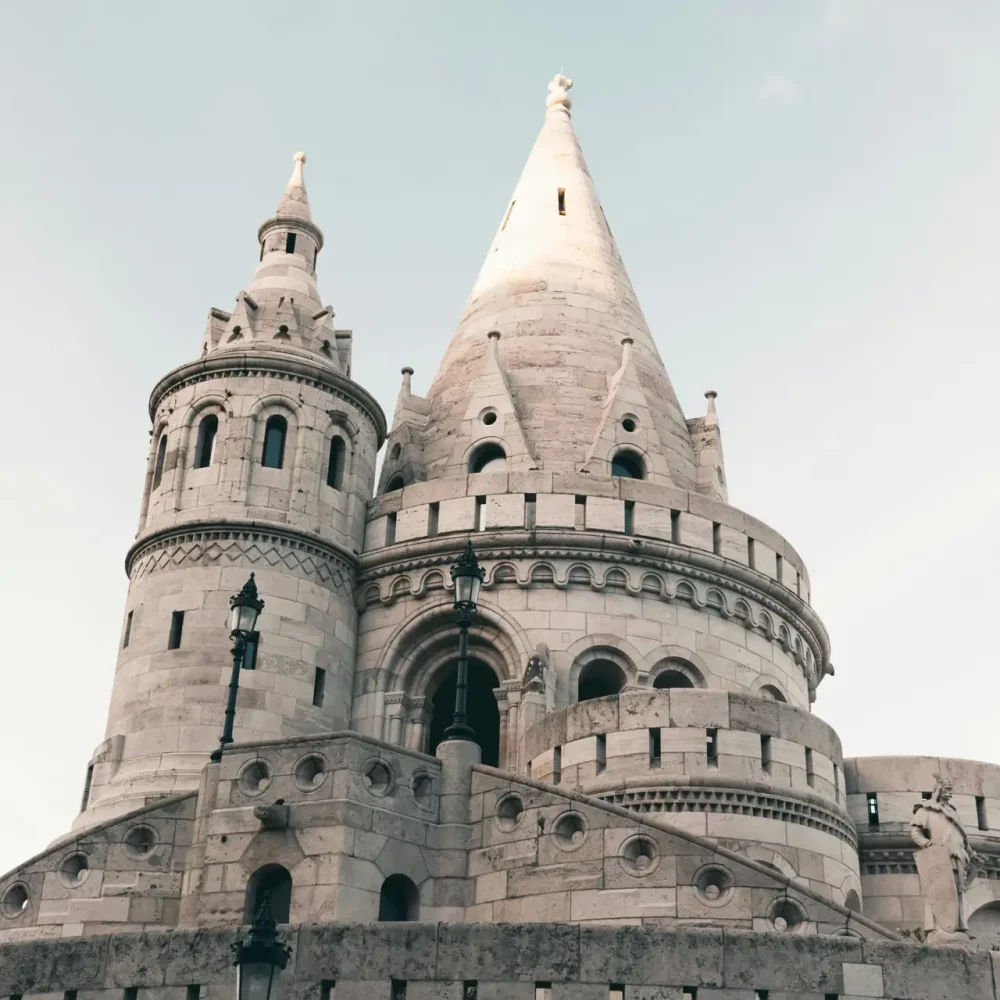 Stunning view of Fisherman's Bastion towers in Budapest, Hungary, captured from below against a clear sky.