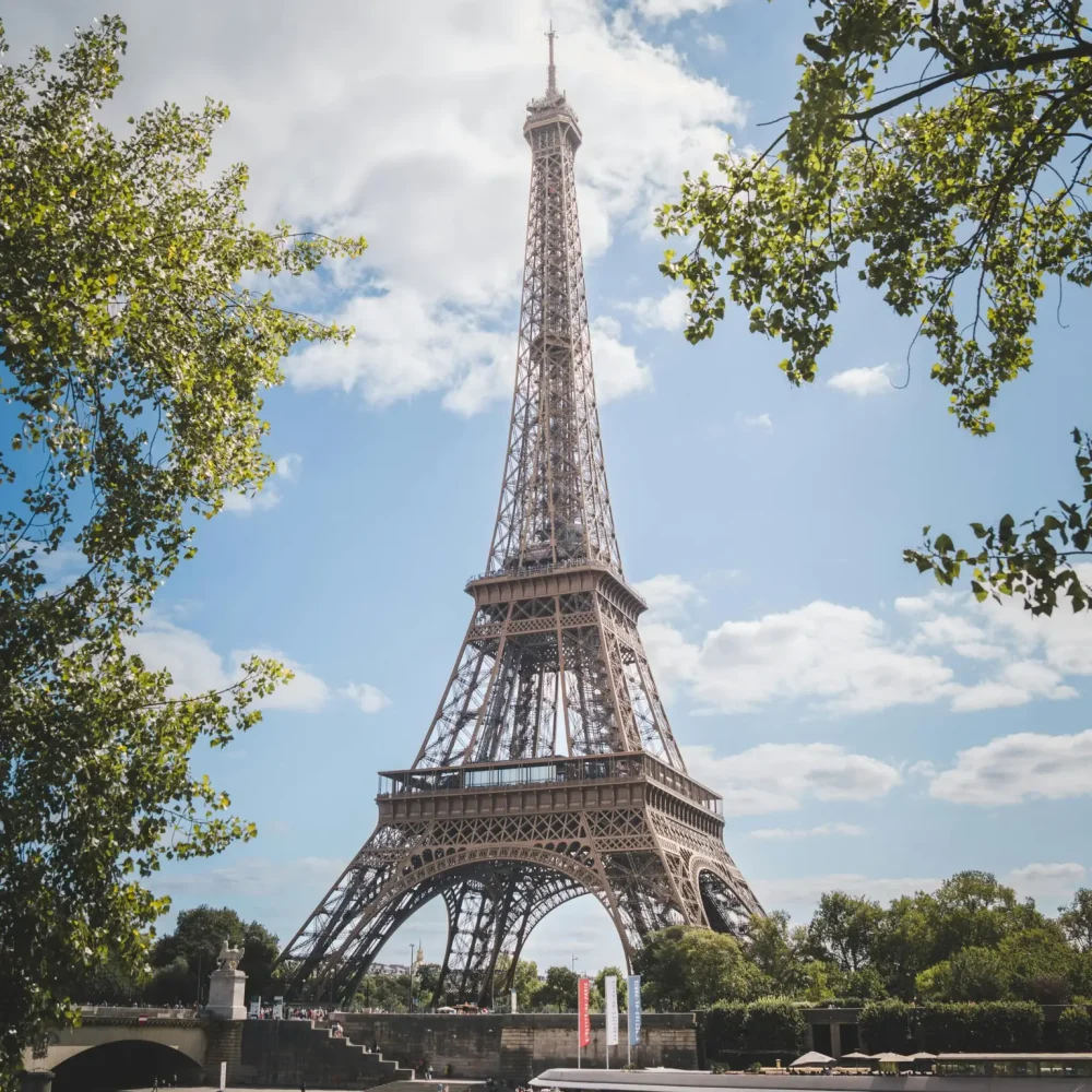 Experience the iconic Eiffel Tower under clear blue skies in Paris, France.